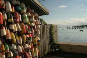 Lobster traps and colorful buoys on fisherman's house in coastal Maine
