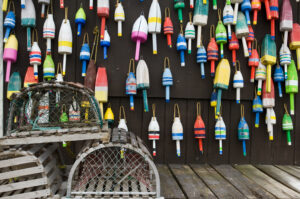 Lobster traps and colorful buoys on fisherman's house in coastal Maine